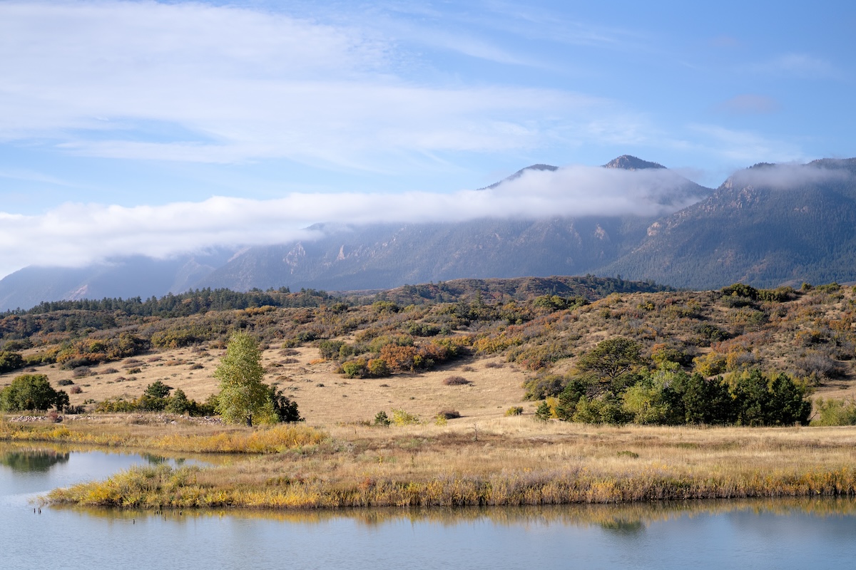 a lake, trees, grasses, and scrub oak on the Colorado Front Range in autumn